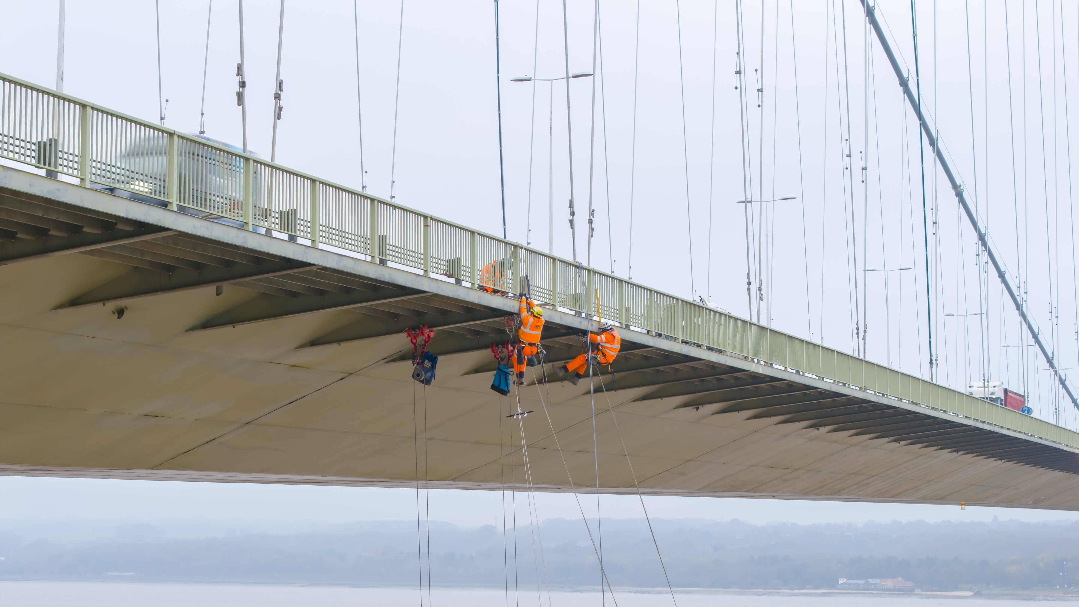 Side view of Humber Bridge with construction workers